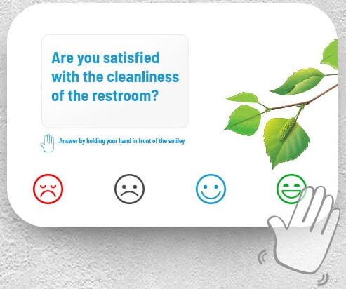 A sign with touchless sensors asking about bathroom experience